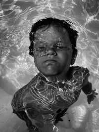 High angle portrait of boy swimming in pool