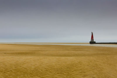Sailboat on beach against clear sky