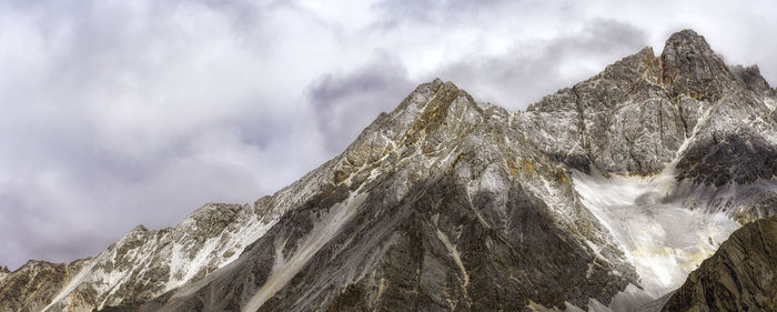 Low angle view of snowcapped mountain against sky