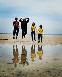 People on beach against sky