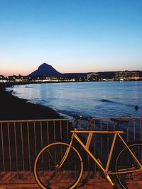 Scenic view of sea against clear sky at dusk