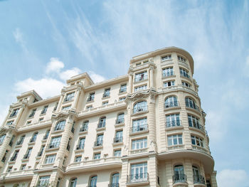 Low angle view of building against cloudy sky