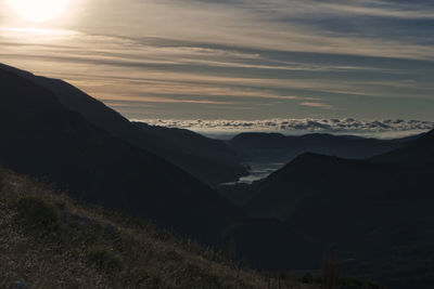 Scenic view of silhouette mountains against sky during sunset