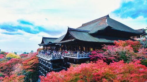 Temple by building against sky