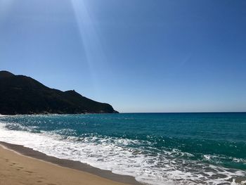 Scenic view of sea against clear blue sky