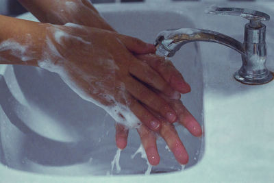 Close-up of human hand in bathroom