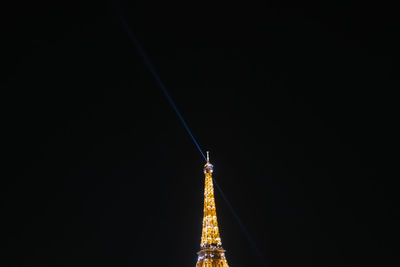 Low angle view of illuminated building against sky at night