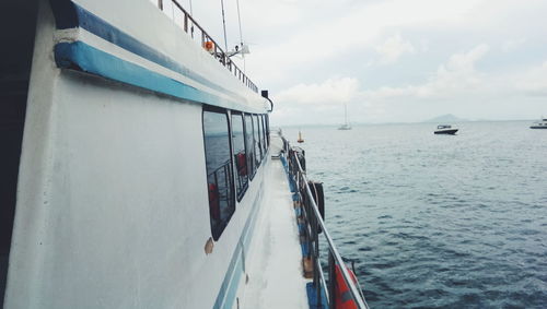 Ship sailing on sea against sky