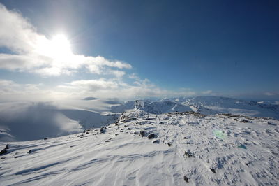 Scenic view of landscape against sky during winter