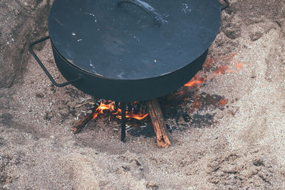 High angle view of fire on barbecue grill on the beach 
