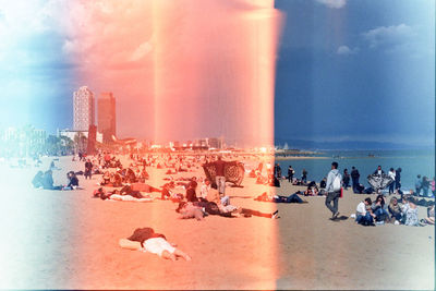 People against cloudy sky