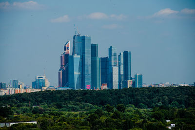 Modern buildings in city against sky