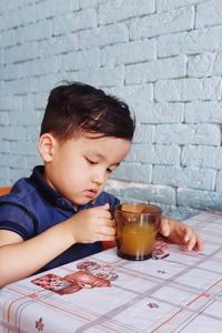 Close-up of boy preparing food at home