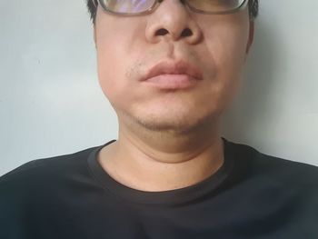 Close-up portrait of young man against white background