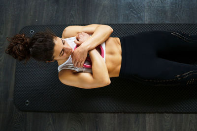 Side view of young woman lying on floor