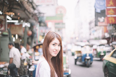 Portrait of woman on street in city