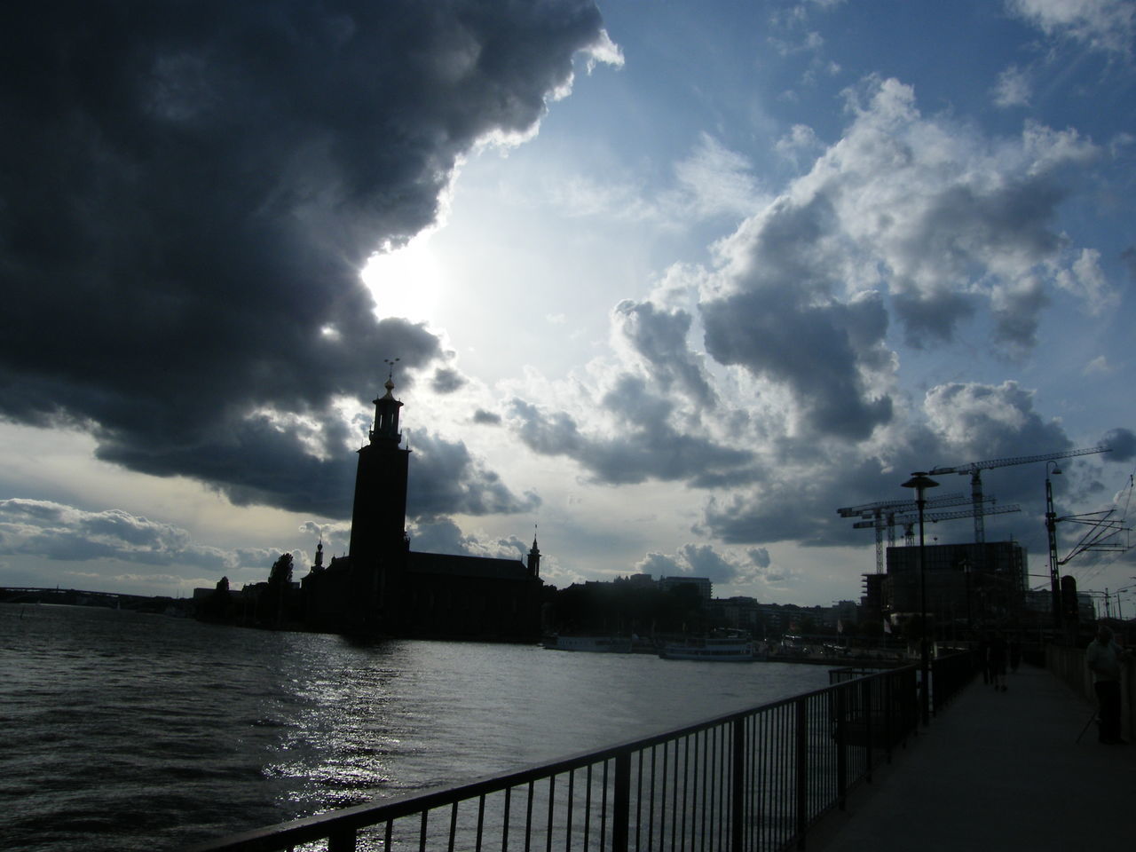 LIGHTHOUSE BY SILHOUETTE BUILDINGS AGAINST SKY