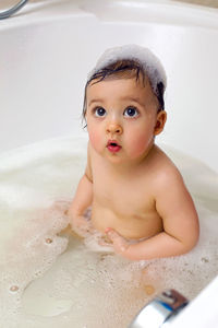 High angle view of cute baby boy in bathtub