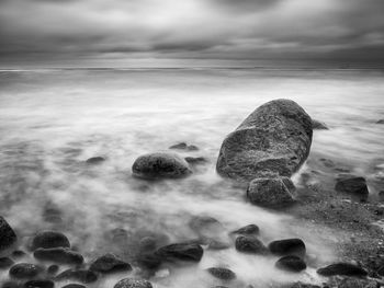 Rocks on beach against sky