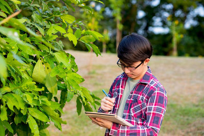 Young woman using mobile phone outdoors