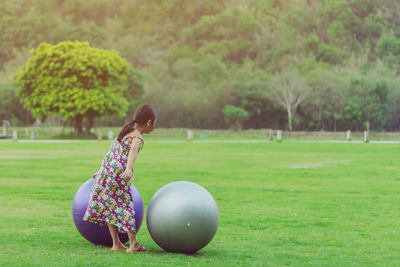 Woman playing with ball on field