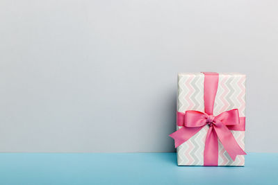 Close-up of gift against white background