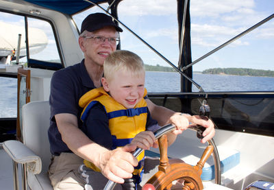 Full length of men sitting in boat