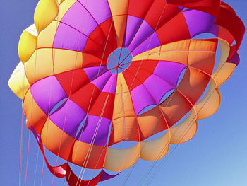 Low angle view of hot air balloon against clear blue sky