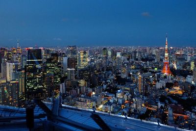 Illuminated cityscape against sky