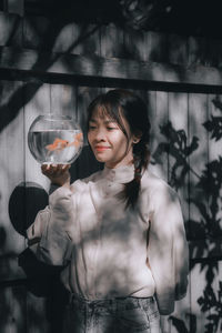 Portrait of young woman holding wineglass