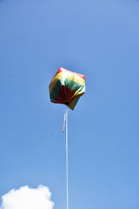 Low angle view of balloon  against blue sky