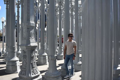 Young man standing against building