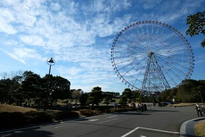 Ferris wheel against cloudy sky