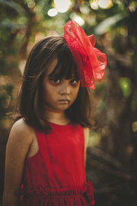 Portrait of a girl with red flower