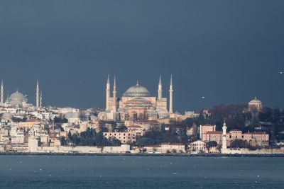 View of buildings in city against clear sky