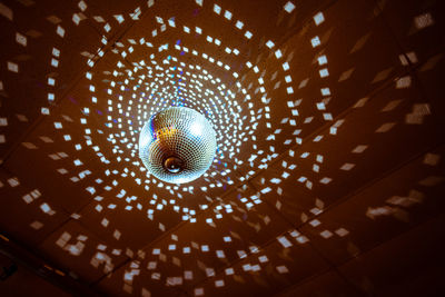 Low angle view of illuminated lights hanging from ceiling