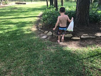 Boy standing on grassy field