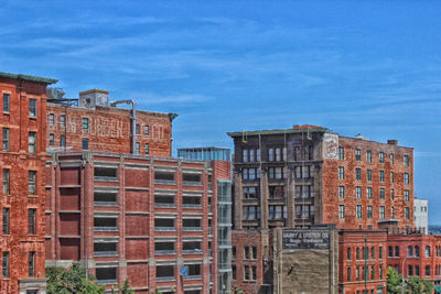 Low angle view of buildings against blue sky