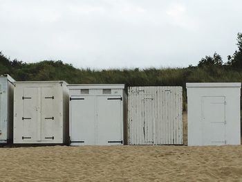 Lifeguard hut on beach against sky