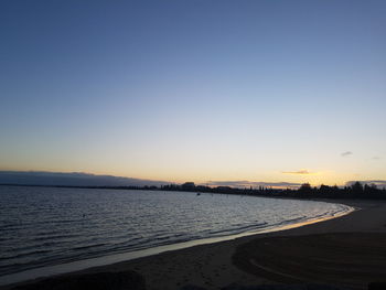 Scenic view of sea against clear sky during sunset