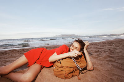 Young woman sitting on beach