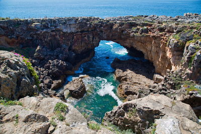 High angle view of rocks on sea shore