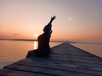Scenic view of pier on sea against sky during sunset