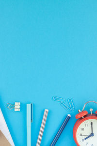 High angle view of clock on blue table