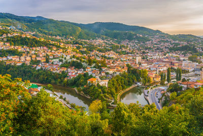 High angle view of townscape and mountains against sky