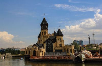 Arch bridge over river against buildings in city