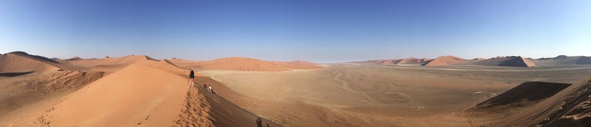 Panoramic view of desert against clear sky