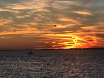 Scenic view of sea against orange sky