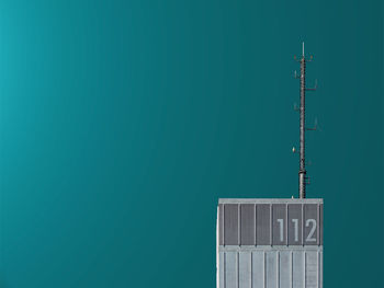 Close-up of communications tower against blue wall