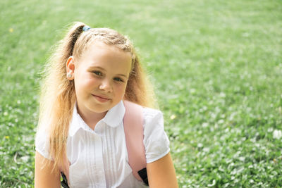 Portrait of young woman standing on field